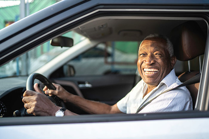 Senior black man driving a car